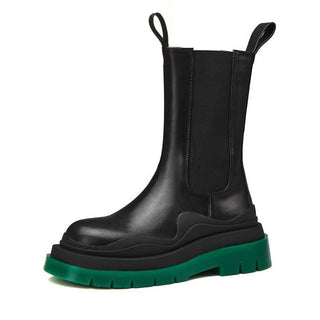Bottes chunky noires mi-hautes à languettes, semelle épaisse verte.
