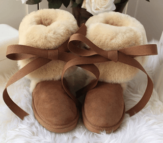 High snow boots made of genuine sheepskin
