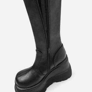 Black leather platform boots with zipper closure